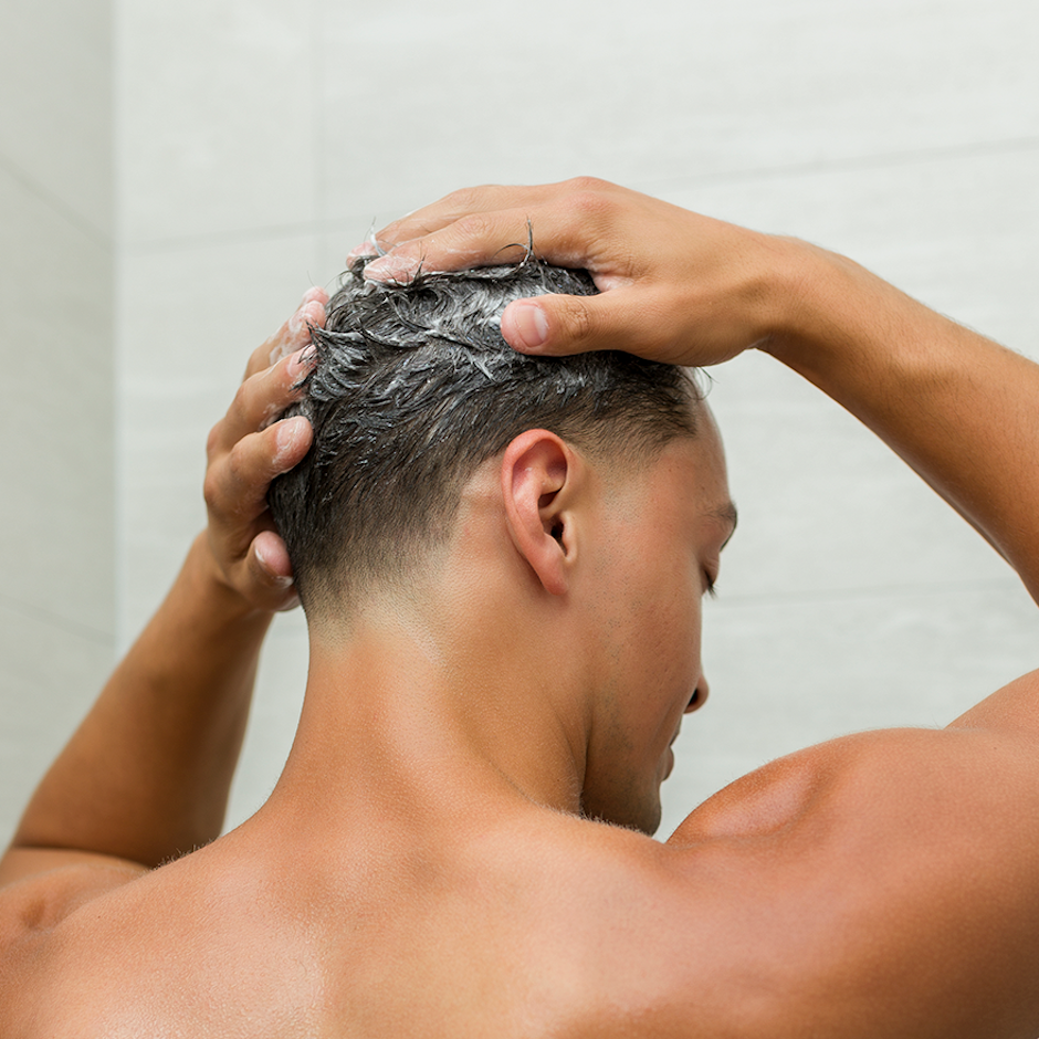 Model washing hair with Grow Shampoo