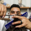 Barber cutting hair with texturizing comb