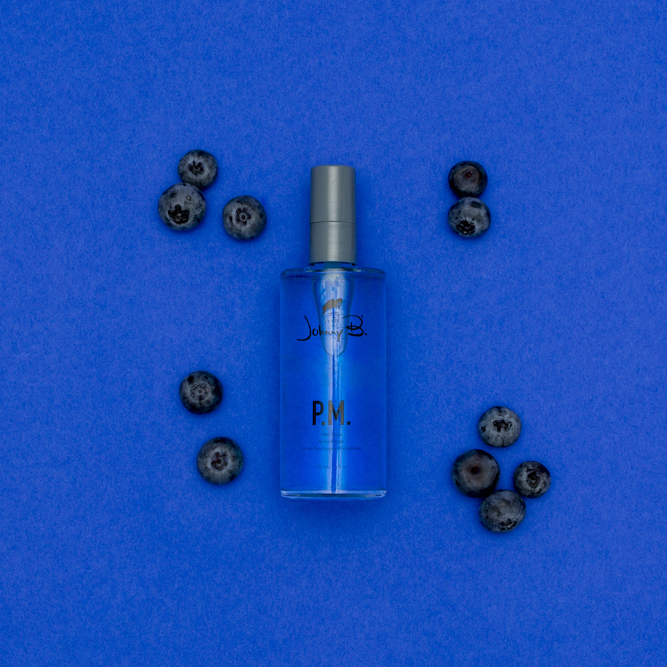 Blueberries laid around a PM After Shave 3.3oz bottle
