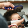 Barber using Vent Brush to style hair