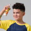 Kid using Juniors Detangler 8oz bottle