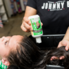 Barber applying Juniors Conditioner 8oz on child's hair
