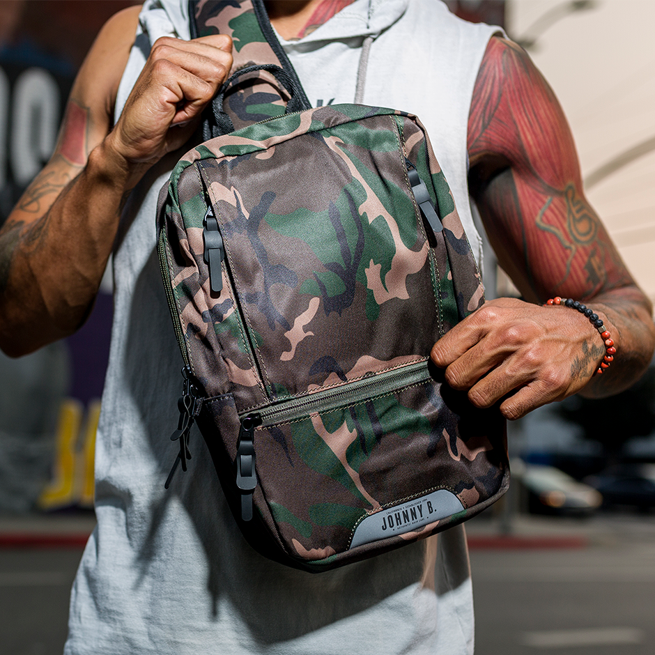 Man holding Camo sling backpack
