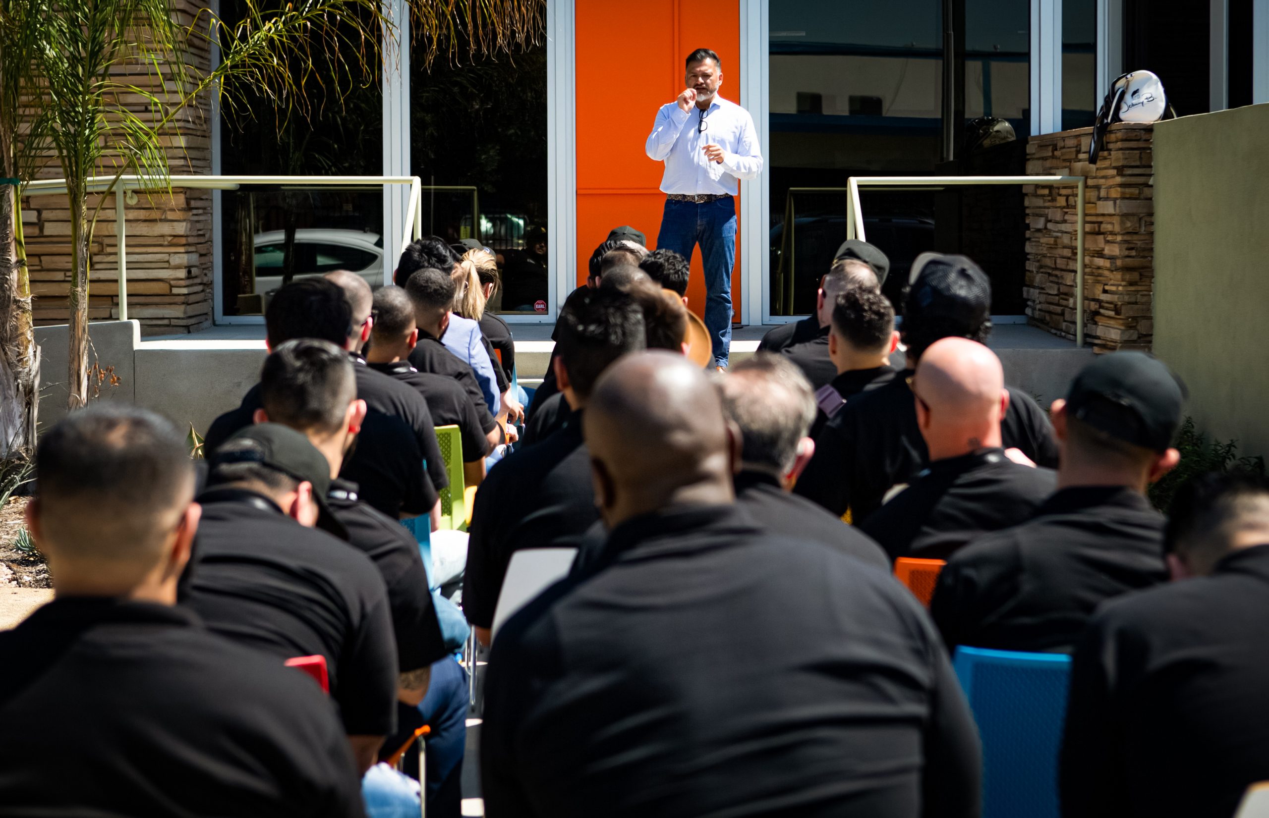 Johnny B CEO talking to group of professionals